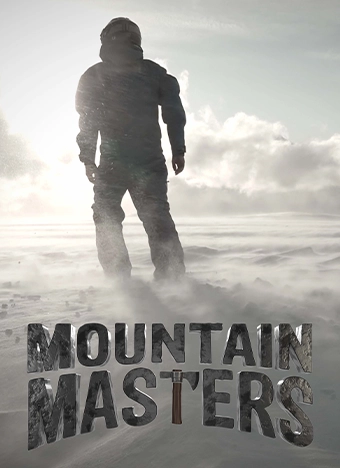 A person standing on the top of a mountain in an outfit to fight the cold harsh air with the title Mountain Masters beneath them