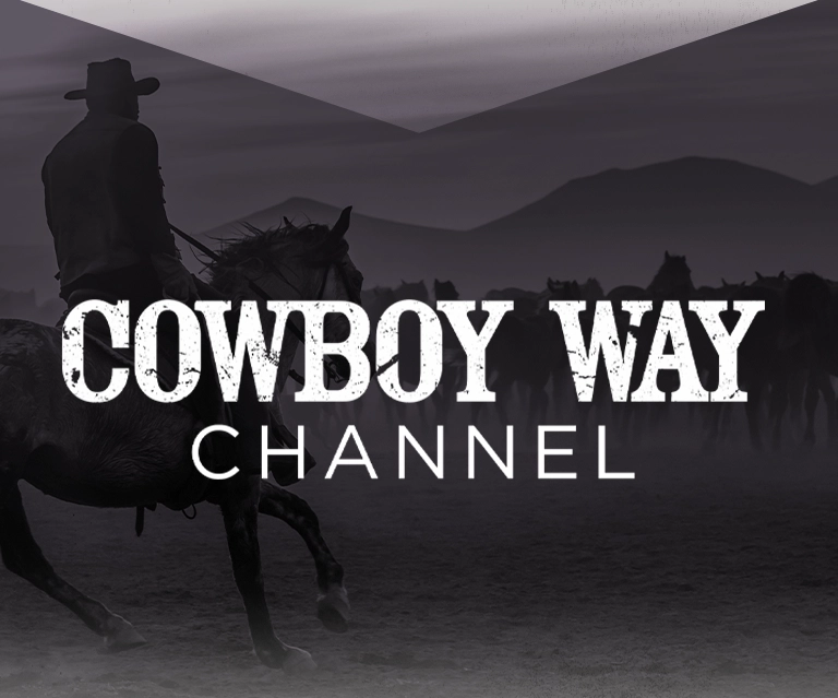 A man on horseback with his back turned towards an open field of cattle and a reins in his hands. The image has a purple overlay on top of it and Cowboy Way Channel in white font.