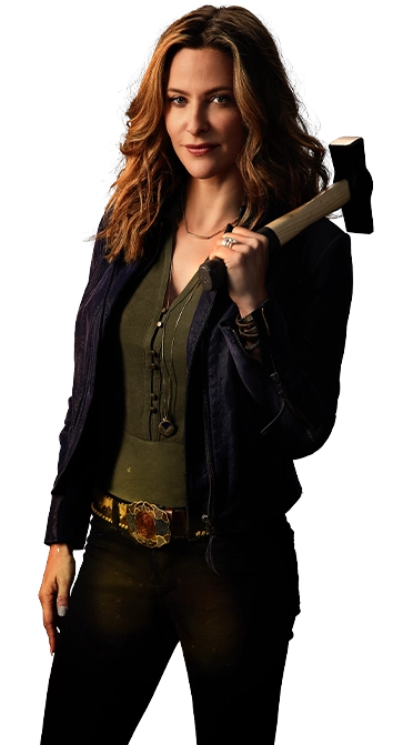 Jill Wagner, host of Handcrafted America, holding a hammer over her shoulder and looking towards the camera.
