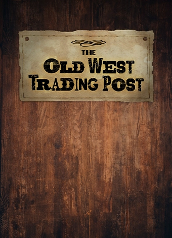 The Old West Trading Post on an old wanted style paper tagged on to a wooden background