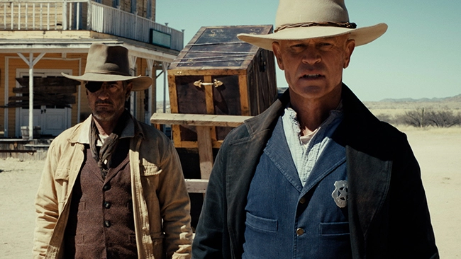Neal McDonough in a cowboy hat as Sherriff John Breaker, ready for action.